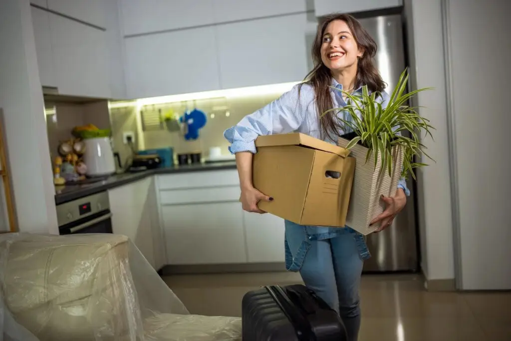 Happy Young Woman Moving into New Apartment